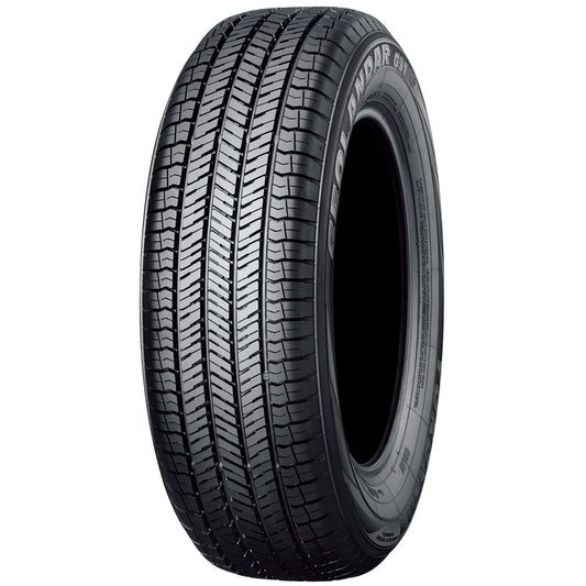 Car tire with tread pattern on a white background