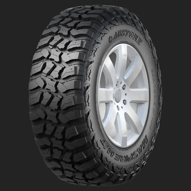 Tire with tread pattern and silver rim on a dark background