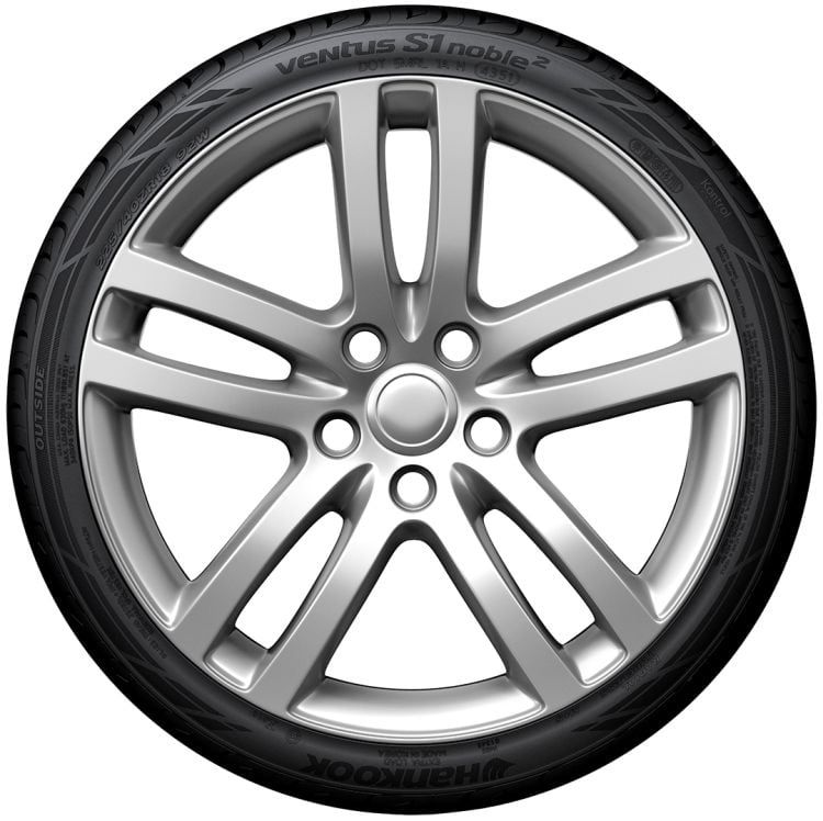 Car wheel with silver rim and black tire on a white background