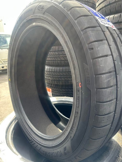 Stack of tires with a close-up on tread pattern and branding.