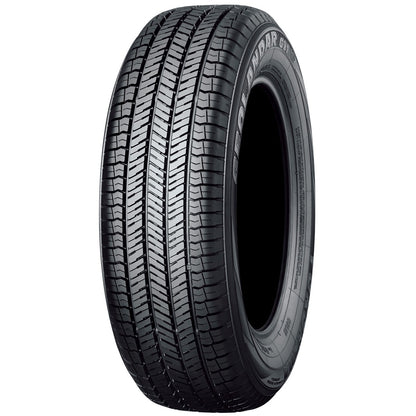 Car tire with tread pattern on a white background